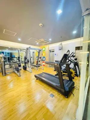 a gym with treadmills and ellipticals in a room at Across NAIA terminal 3 in Manila