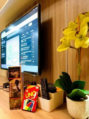 a computer monitor sitting on a desk next to a plant at Across NAIA terminal 3 in Manila