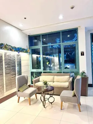 a living room with a couch and two chairs and a table at Across NAIA terminal 3 in Manila
