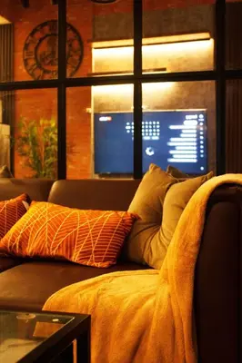 a couch with pillows on it in a living room at The Brick and Wood Suite Industrial Haven in Makati in Manila
