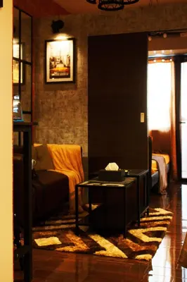 a living room with a couch and a table at The Brick and Wood Suite Industrial Haven in Makati in Manila
