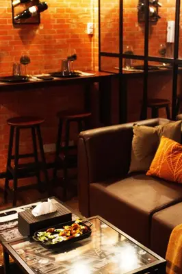 a living room with a couch and a table at The Brick and Wood Suite Industrial Haven in Makati in Manila