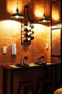 a room with a counter with a bunch of wine bottles at The Brick and Wood Suite Industrial Haven in Makati in Manila