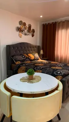 a bedroom with a table and a bed at Modern Studio near MOA, Airport & Heart of Pasay in Manila