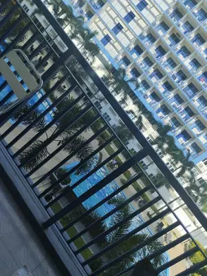 an overhead view of a large apartment building with palm trees at Bini Comfort room in Manila