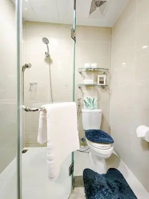 a bathroom with a toilet and a shower at LARGE One Bedroom Unit In Uptown BGC in Manila