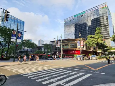 a city street with a crosswalk in a city with buildings at LARGE One Bedroom Unit In Uptown BGC in Manila