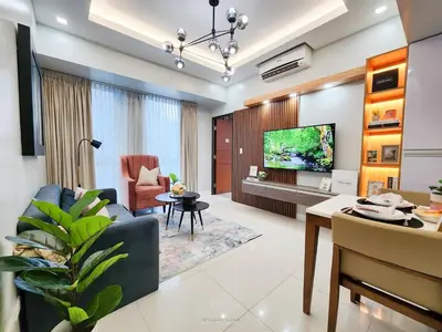 a living room with a couch and a tv at LARGE One Bedroom Unit In Uptown BGC in Manila