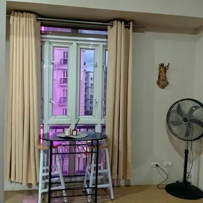 a room with a table and a large window at Cozy Jen 150newport Boulevard condotel in Manila