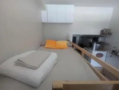 a small room with a bed and a kitchen at Rustic condo in Makati CBD in Manila