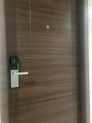 a wooden door with a remote control on it at Rustic condo in Makati CBD in Manila