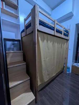 a bunk bed with stairs in a room at Rustic condo in Makati CBD in Manila