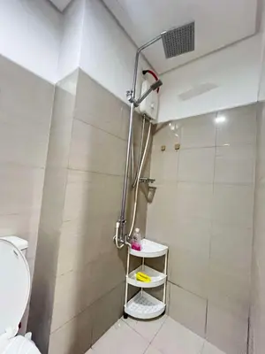 a shower in a bathroom with a toilet at Affordable Condo staycation near MOA ,NAIA & Airport 4 GUESTS WIFI,NETFLIX,POOL in Manila