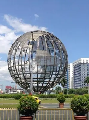 a large metal object in the middle of a city at Snuggle Suites in Manila