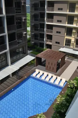 a swimming pool in the middle of a apartment building at Moa Gentry Manor WIFI TV Balcony with view Beside Okada in Manila