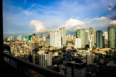 a view of a large city with tall buildings at Snug Stay in Gramercy Makati with City Skyline View! in Manila