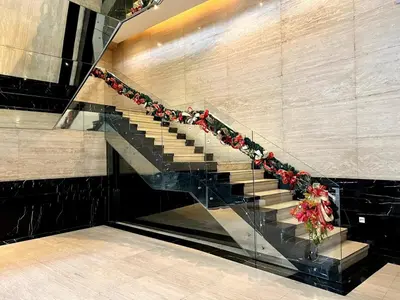 a staircase in a building with flowers on it at Snug Stay in Gramercy Makati with City Skyline View! in Manila