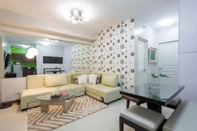 a living room with a couch and a table at NEW 2BR Family Home with FREE Parking & Fiber Wi-Fi in Manila