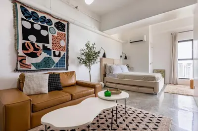 a living room with a couch and a bed at Kael Studio in Manila