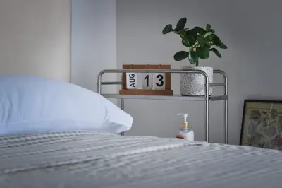 a bedroom with a bed and a clock on a shelf at Kael Studio in Manila