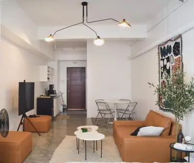 a living room with a couch and a table at Kael Studio in Manila