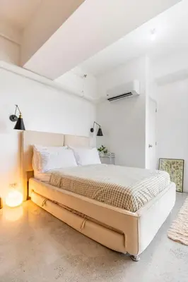 a bedroom with a large bed in a white room at Kael Studio in Manila