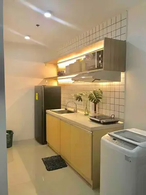 a kitchen with a sink and a refrigerator at Modern Tropical Home In The Heart of Quezon City in Manila