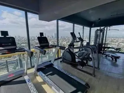 a gym with a view of the city at Modern Tropical Home In The Heart of Quezon City in Manila