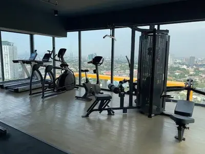 a gym with treadmills and exercise equipment in a building at Modern Tropical Home In The Heart of Quezon City in Manila