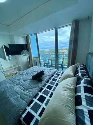 a cat laying on top of a bed in a bedroom at The Dream Den Staycation in Manila