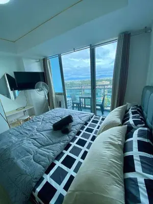 a cat laying on top of a bed in a bedroom at The Dream Den Staycation in Manila