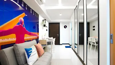 a living room with a couch and a table at Best 1BR in Uptown BGC - Near Mitsukoshi & Malls in Manila