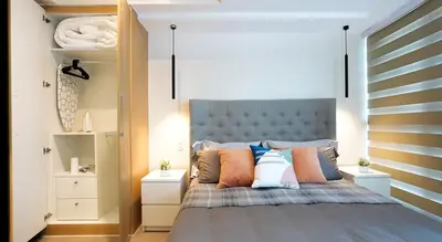 a bedroom with a large bed with pillows on it at Best 1BR in Uptown BGC - Near Mitsukoshi & Malls in Manila