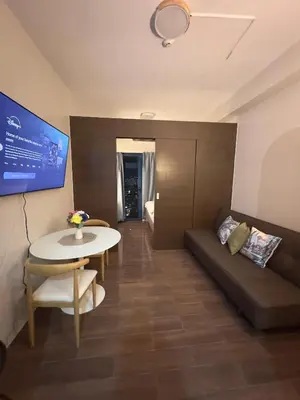 a living room with a couch and a table at Comfy Makati Condo Wifi, Netflix and Disney in Manila