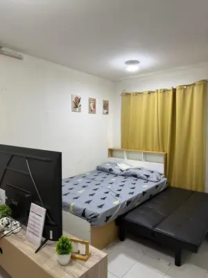 a bedroom with a bed and a desk with a television at At Home in Santa Rosa in Santa Rosa