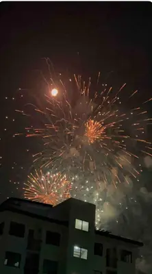 a fireworks display in the sky over a building at At Home in Santa Rosa in Santa Rosa