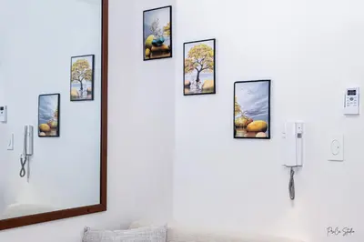 a mirror on a white wall with pictures on it at Condo in Makati Staycation in Manila