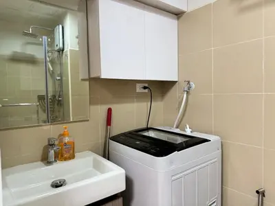 a bathroom with a sink and a toilet and a mirror at 1230 Flor Suite Shore 3 Residences near SM MOA by PrimeStay in Manila