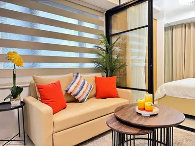 a living room with a couch and a table at 1230 Flor Suite Shore 3 Residences near SM MOA by PrimeStay in Manila