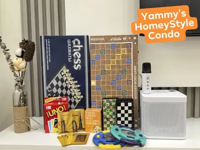 a table with books and other items on it at Yammy's HomeyStyle Condo at Tower 3 Shore 3 Residences in Manila