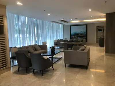 a living room with couches and chairs and a table at Yammy's HomeyStyle Condo at Tower 3 Shore 3 Residences in Manila