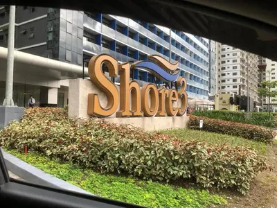 a sign for a store in front of a building at Yammy's HomeyStyle Condo at Tower 3 Shore 3 Residences in Manila