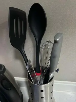 a container filled with utensils on a counter at Eve's Den in Manila