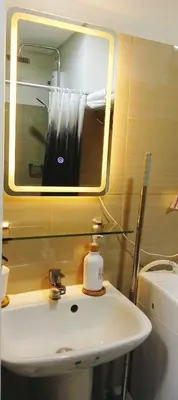 a bathroom with a sink and a mirror and a toilet at Staycation At Shore 2 Residences Tower 2 in Manila