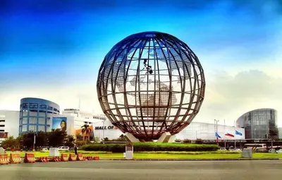 a large sphere sculpture in front of a building at Staycation At Shore 2 Residences Tower 2 in Manila