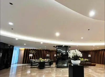 a lobby with couches and flowers in a building at Staycation At Shore 2 Residences Tower 2 in Manila