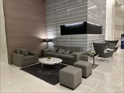 a living room with a couch and a table and chairs at Luxury in the Makati Skyline in Manila