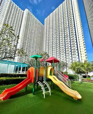 a playground in front of a large building at Luxury in the Makati Skyline in Manila