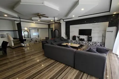 a living room with a couch and a tv at Jewelry Resort and Villas Tagaytay in Silang
