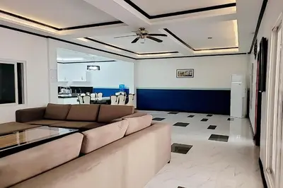 a living room with a couch and a ceiling fan at Jewelry Resort and Villas Tagaytay in Silang